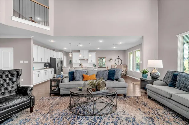 a living room with furniture kitchen view and a table