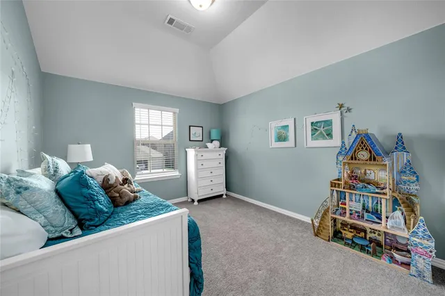 a living room with furniture and a book shelf