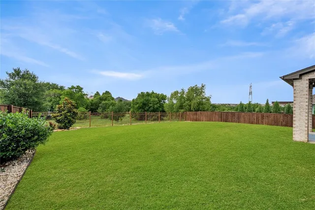 a view of a patio with table and chairs with wooden fence