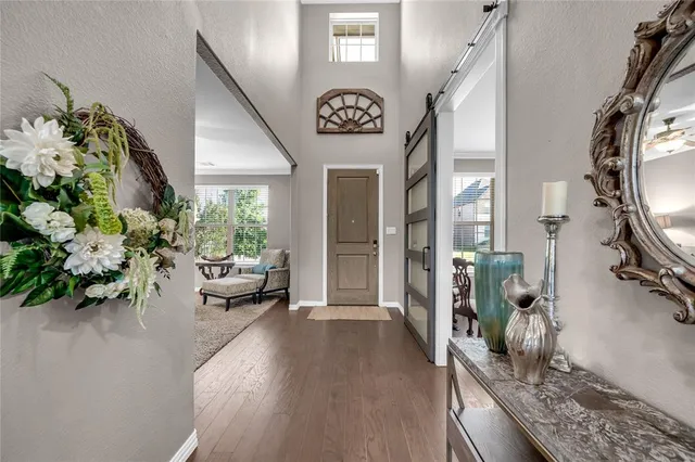 a view of living room filled with furniture and a chandelier