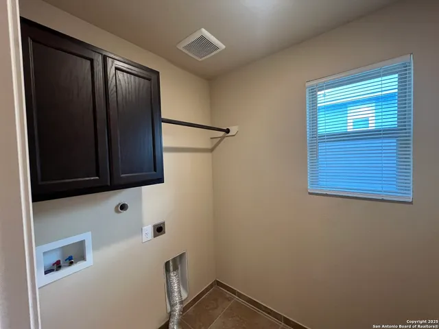 an empty room with a bench and a window