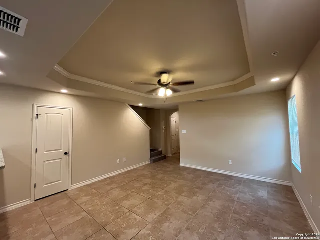 an empty room with closet and a chandelier fan