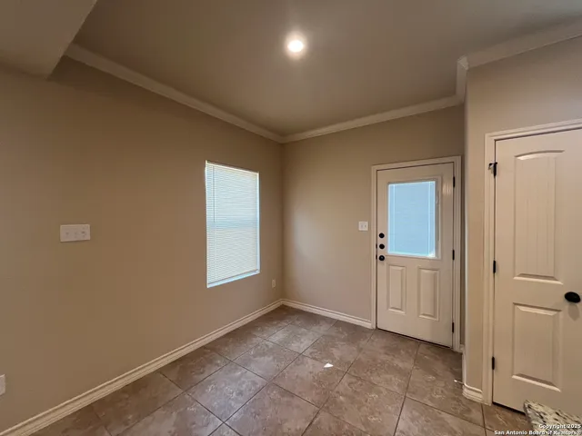 an empty room with windows and closet