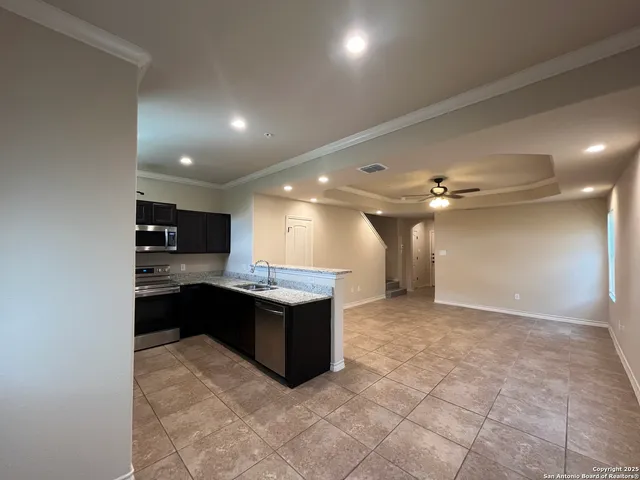 a view of kitchen with stainless steel appliances a sink and cabinets