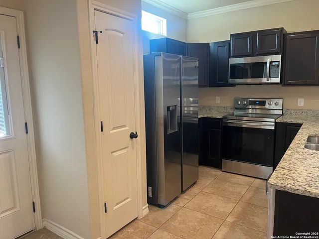 a kitchen with stainless steel appliances granite countertop a refrigerator and a sink