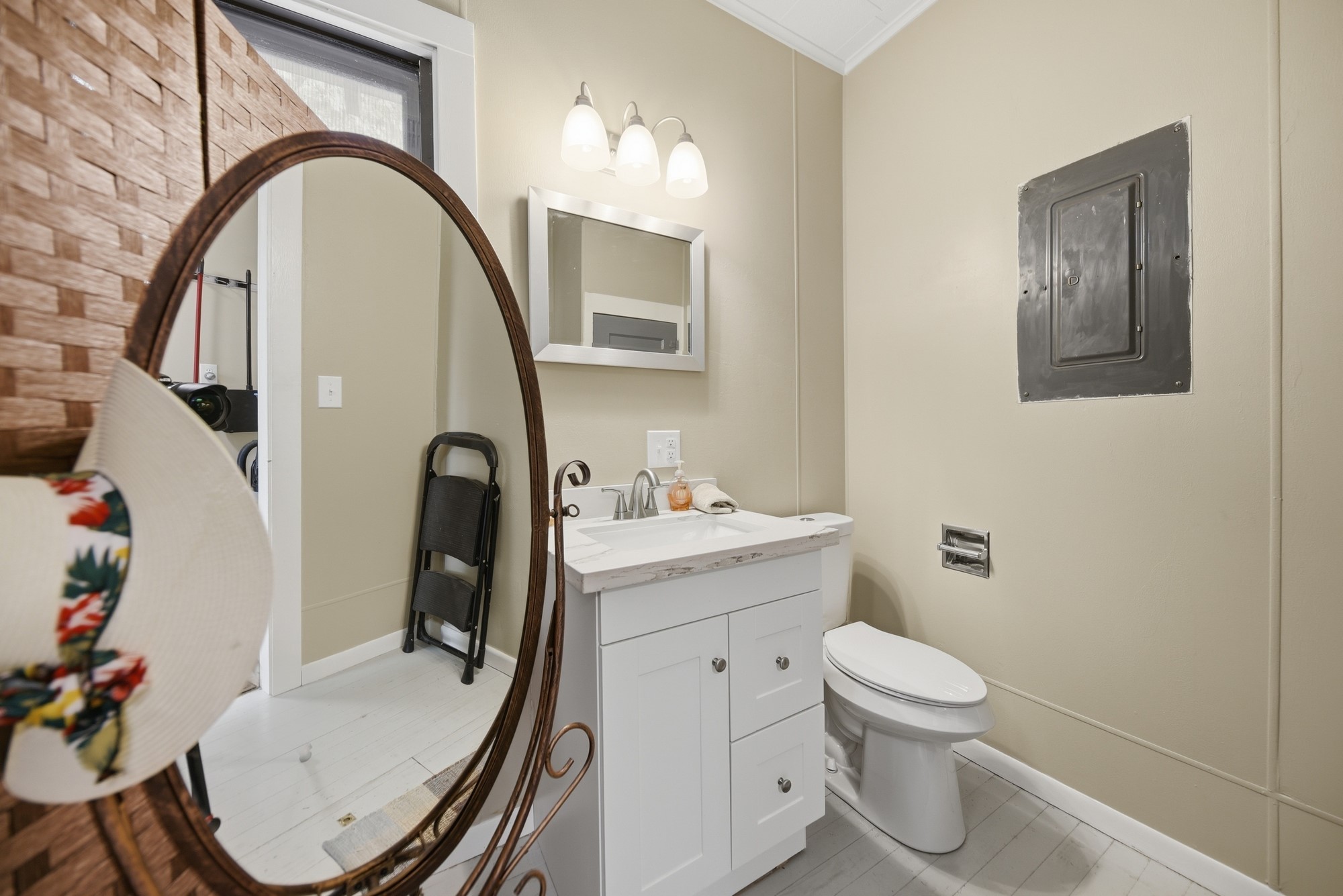 1501 South Austin Street Brenham, TX 77833 - Photo 23 of 36 a bathroom with a sink a toilet and a mirror