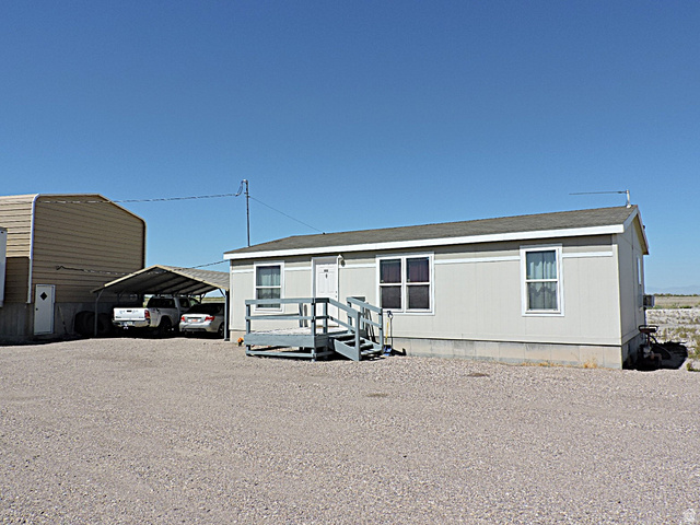 915 North 5000 W Road Hinckley, UT 84635 - Photo 23 of 27 Single-story residence featuring light gray siding and white trim