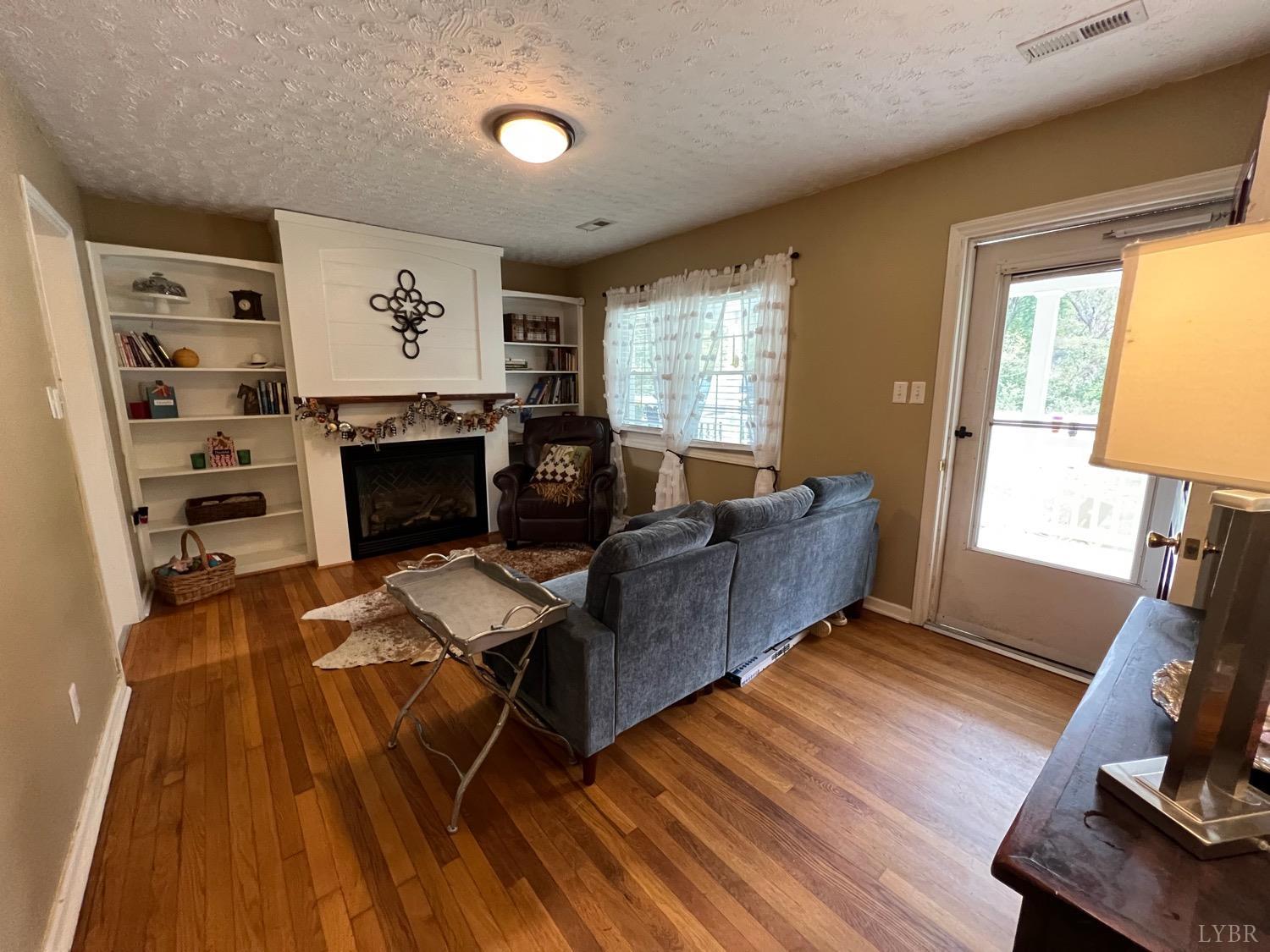 857 Woodson Road Roseland, VA 22967 - Photo 2 of 31 a living room with furniture and a fireplace