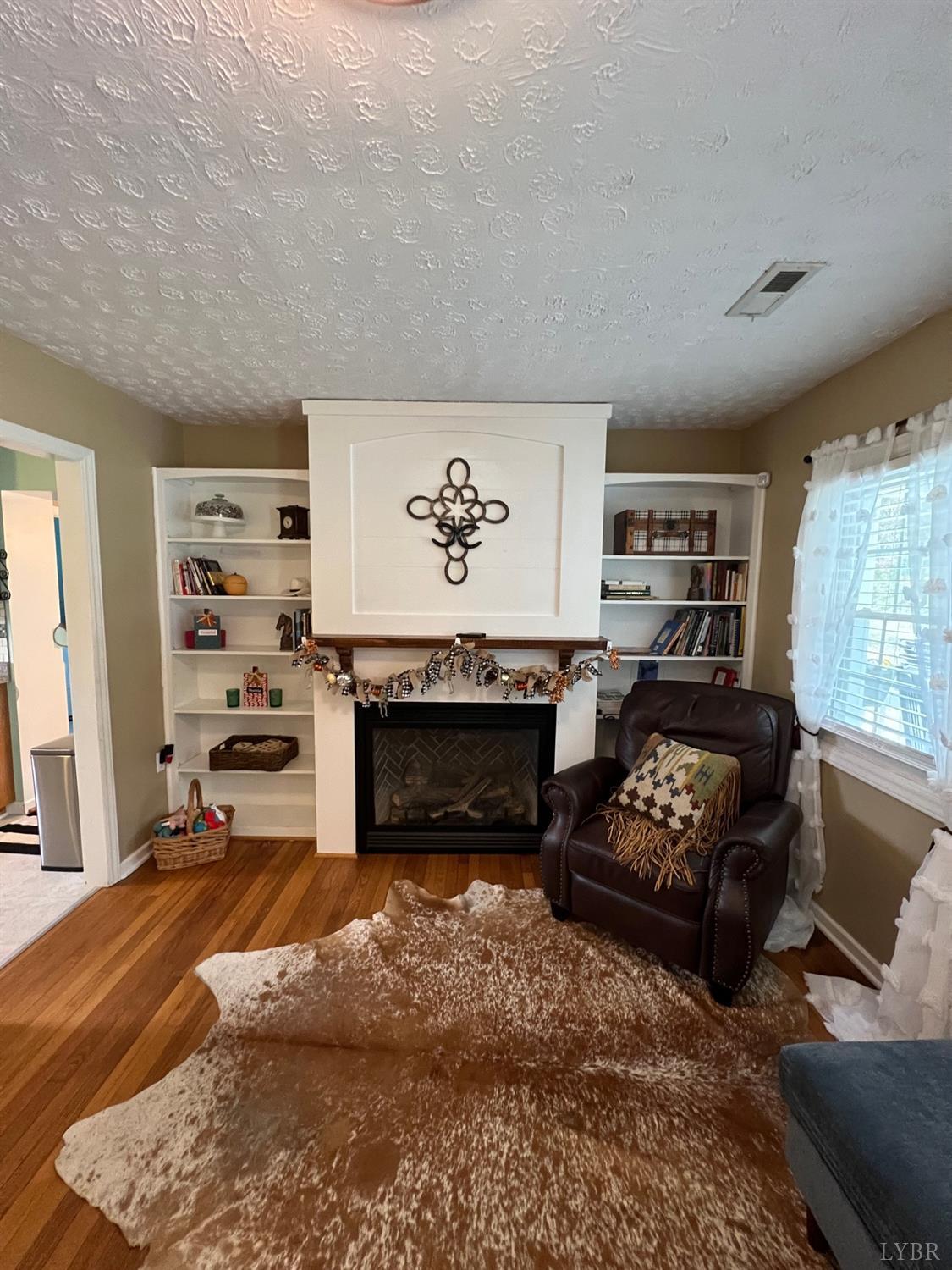 857 Woodson Road Roseland, VA 22967 - Photo 3 of 31 a living room with furniture and a fireplace