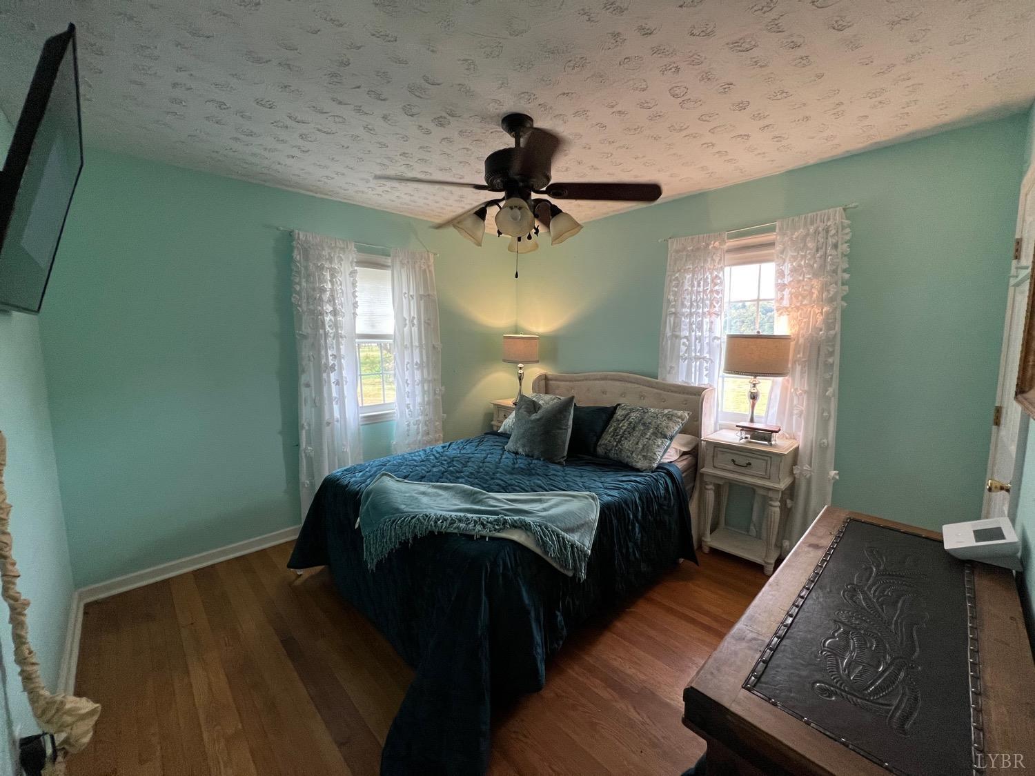 857 Woodson Road Roseland, VA 22967 - Photo 10 of 31 a bedroom with bed wooden floor and window