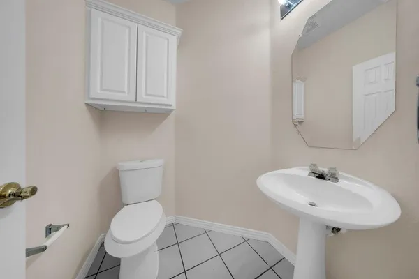 a bathroom with a sink toilet and a mirror