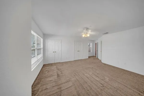 a view of an empty room and a window