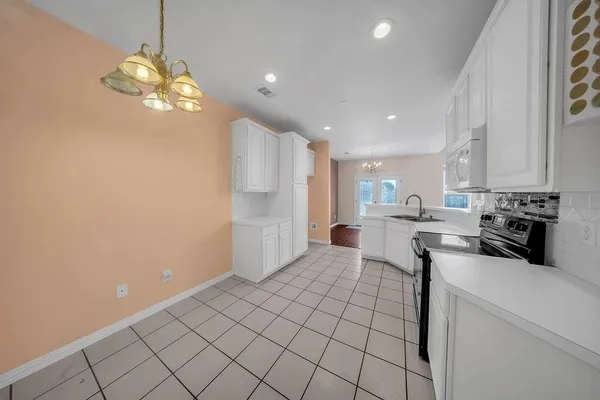 a kitchen with stainless steel appliances a refrigerator sink and microwave