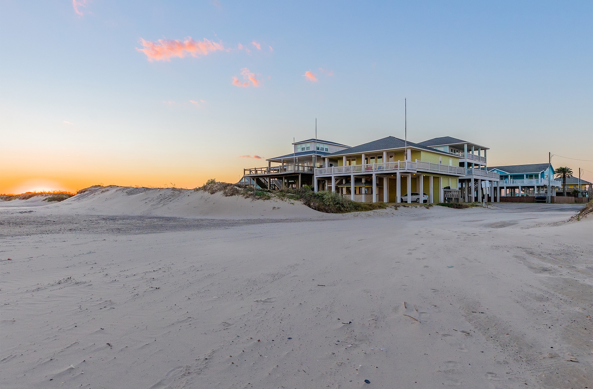 843 South Jacks Road Crystal Beach, TX 77650 - Photo 5 of 45 Direct beach access for all ocean lovers! The setting sun adds a warm glow, enhancing the coastal ambiance.