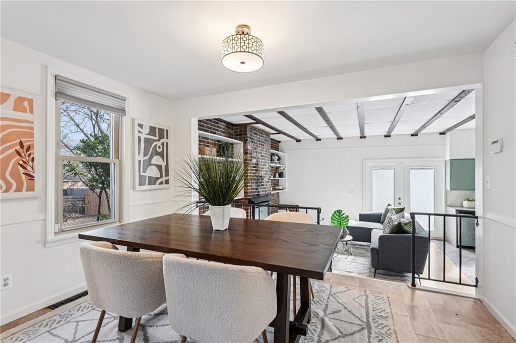 2226 Whites Mill Road Decatur, GA 30032 - Photo 13 of 51 a view of a dining room with furniture and wooden floor