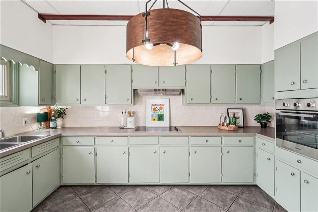 2226 Whites Mill Road Decatur, GA 30032 - Photo 16 of 51 a kitchen with a sink dishwasher and white cabinets