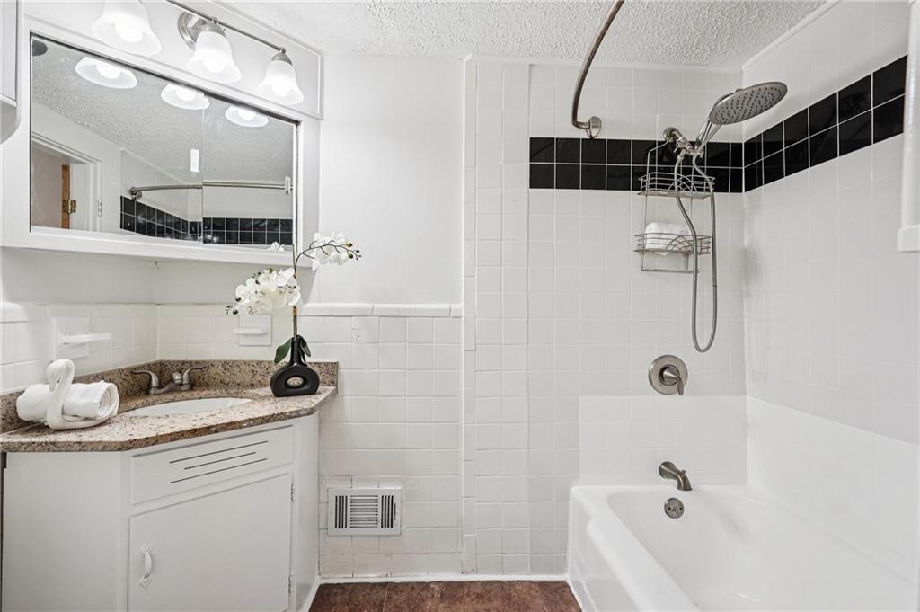 2226 Whites Mill Road Decatur, GA 30032 - Photo 25 of 51 a bathroom with a bathtub and a shower