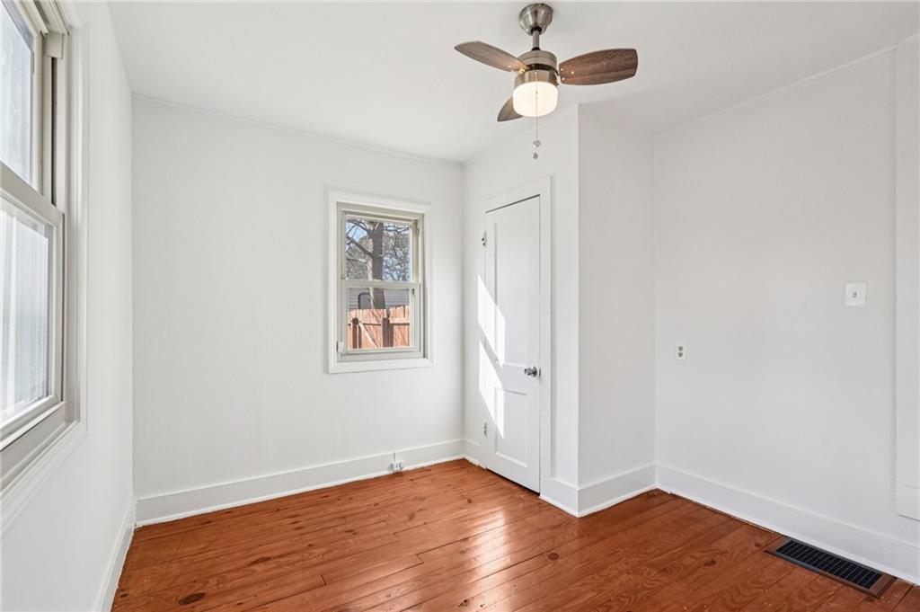 2226 Whites Mill Road Decatur, GA 30032 - Photo 29 of 51 an empty room with wooden floor fan and windows
