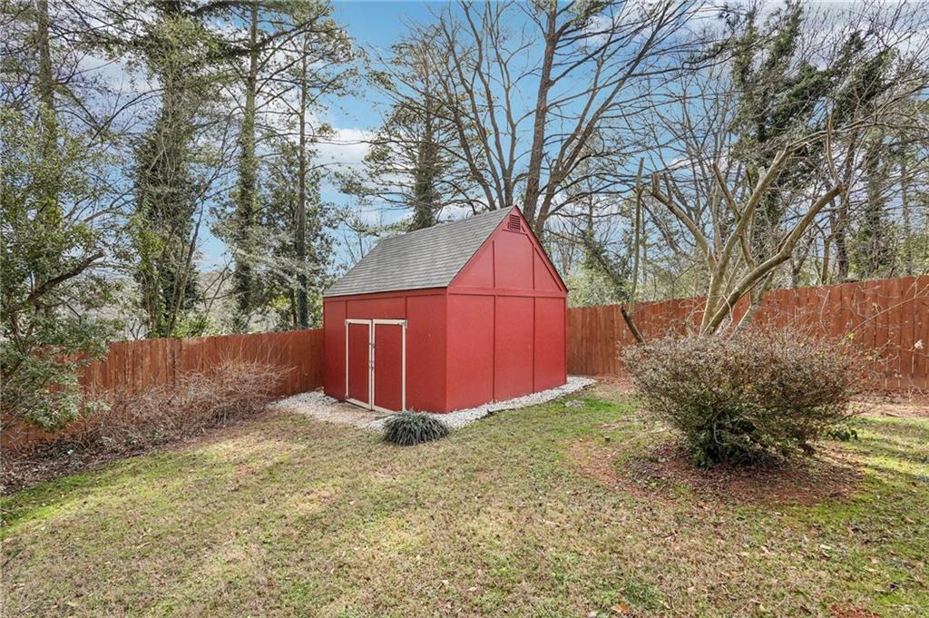 2226 Whites Mill Road Decatur, GA 30032 - Photo 35 of 51 a view of backyard with large tree and wooden fence