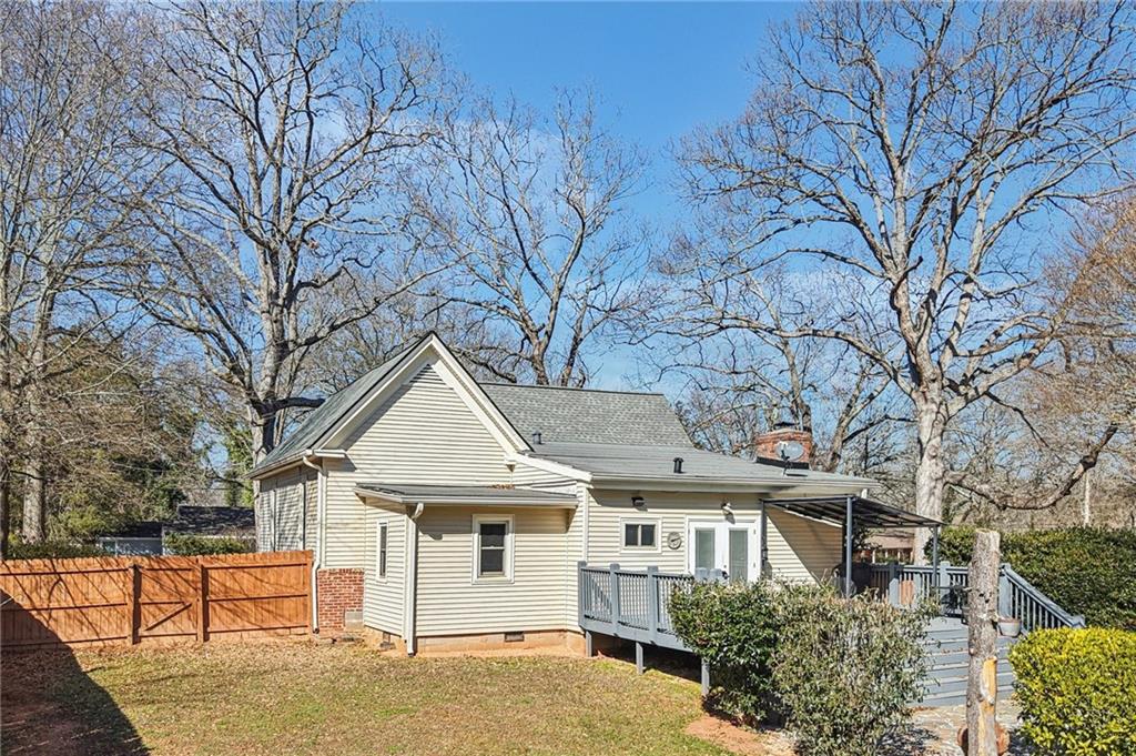 2226 Whites Mill Road Decatur, GA 30032 - Photo 48 of 51 a view of white house with a large tree and wooden fence