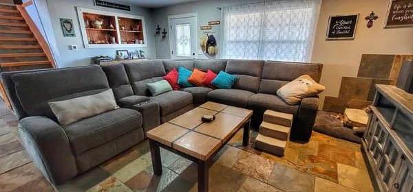 a living room with furniture and a fireplace