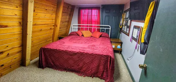 a bedroom with a bed and a window