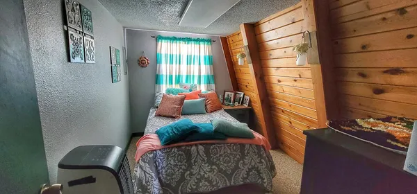 a utility room with wooden floor washer and dryer