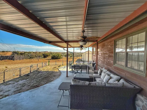 a view of an outdoor sitting area with furniture