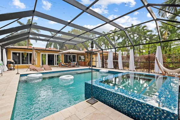 a swimming pool with outdoor seating and yard