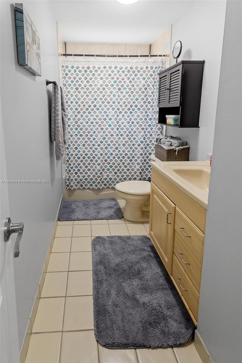 Tamiami Miami, FL 33182 - Photo 16 of 47 a bathroom with a sink toilet and mirror