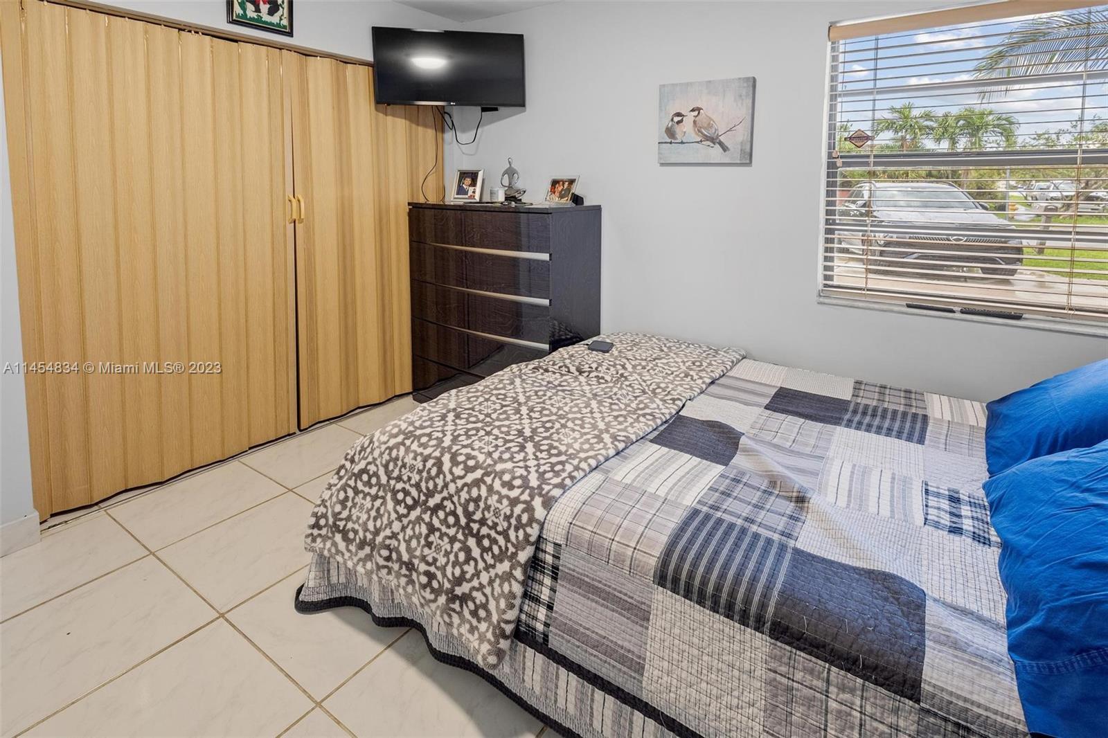 Tamiami Miami, FL 33182 - Photo 20 of 47 a bedroom with a bed and a window