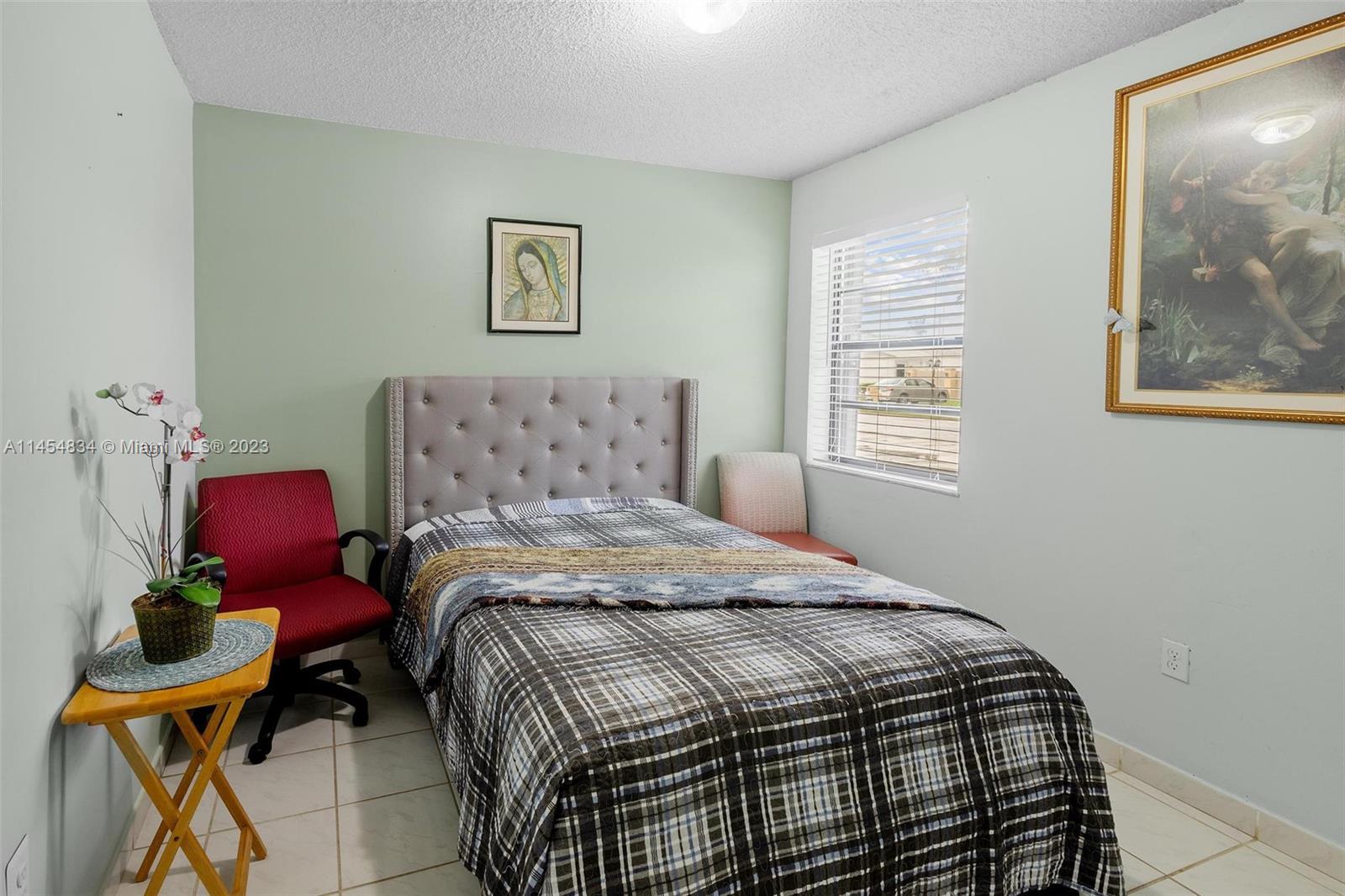 Tamiami Miami, FL 33182 - Photo 21 of 47 a bedroom with a bed and wooden floor