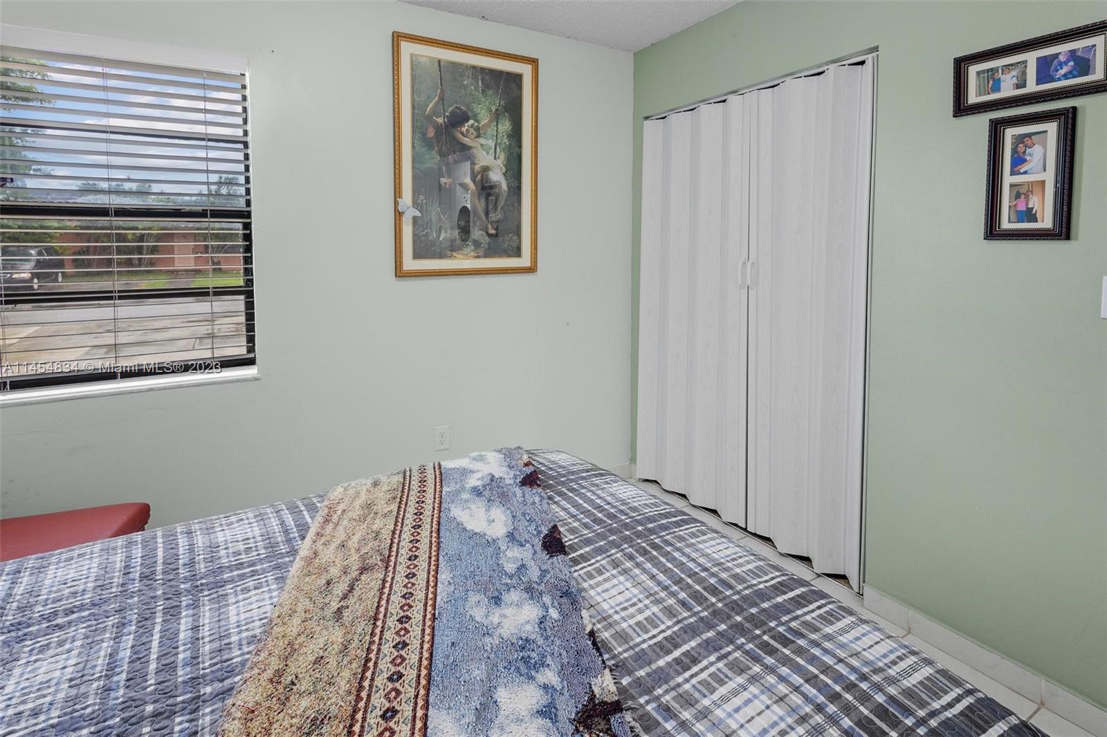 Tamiami Miami, FL 33182 - Photo 22 of 47 a bedroom with a bed and a window