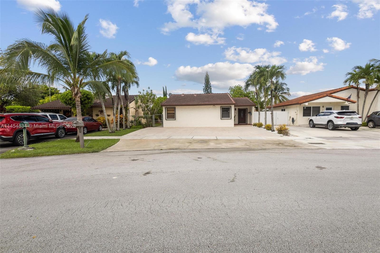 Tamiami Miami, FL 33182 - Photo 35 of 47 a white house with palm tree in front of it