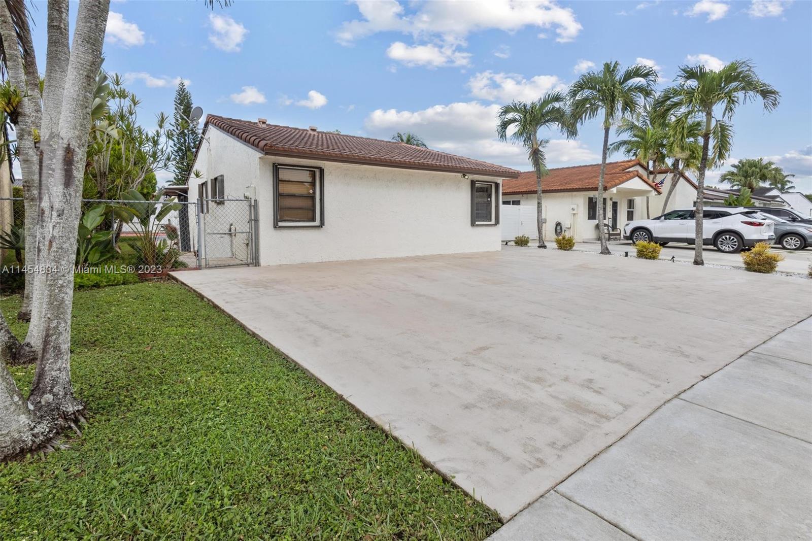 Tamiami Miami, FL 33182 - Photo 36 of 47 a front view of house with yard and outdoor seating