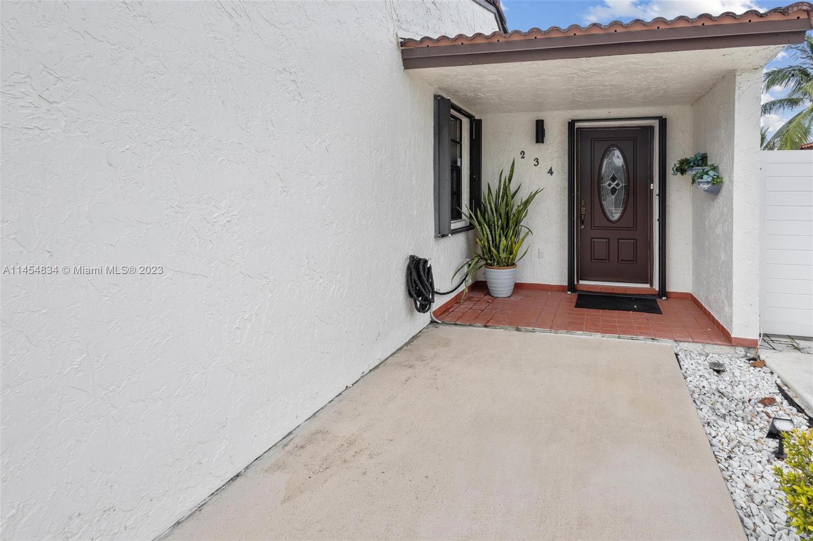 Tamiami Miami, FL 33182 - Photo 4 of 47 a view of a hallway with wooden floor and a potted plant