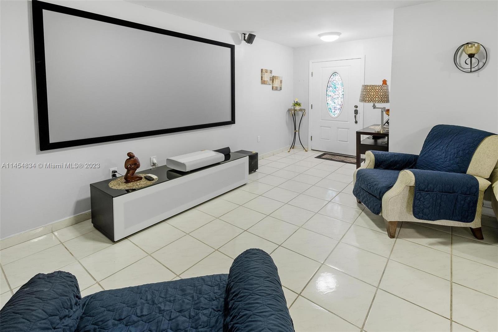 Tamiami Miami, FL 33182 - Photo 5 of 47 a living room with a couch and a flat screen tv