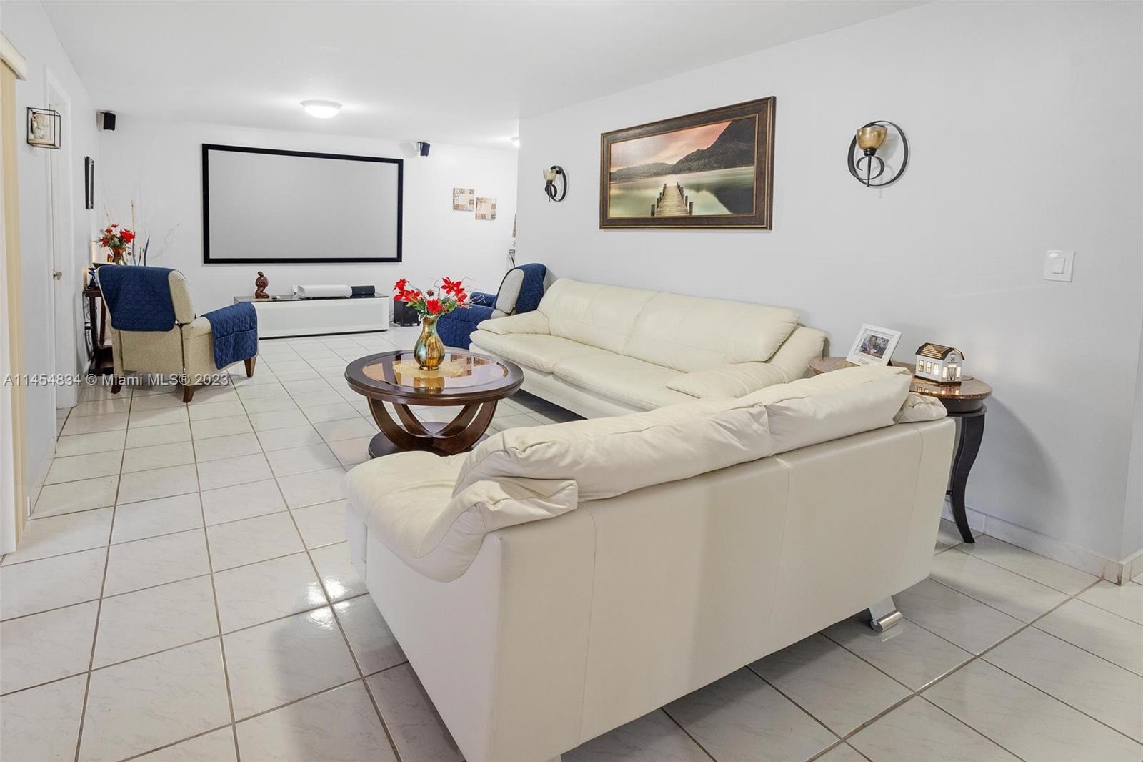 Tamiami Miami, FL 33182 - Photo 7 of 47 a living room with furniture and a flat screen tv