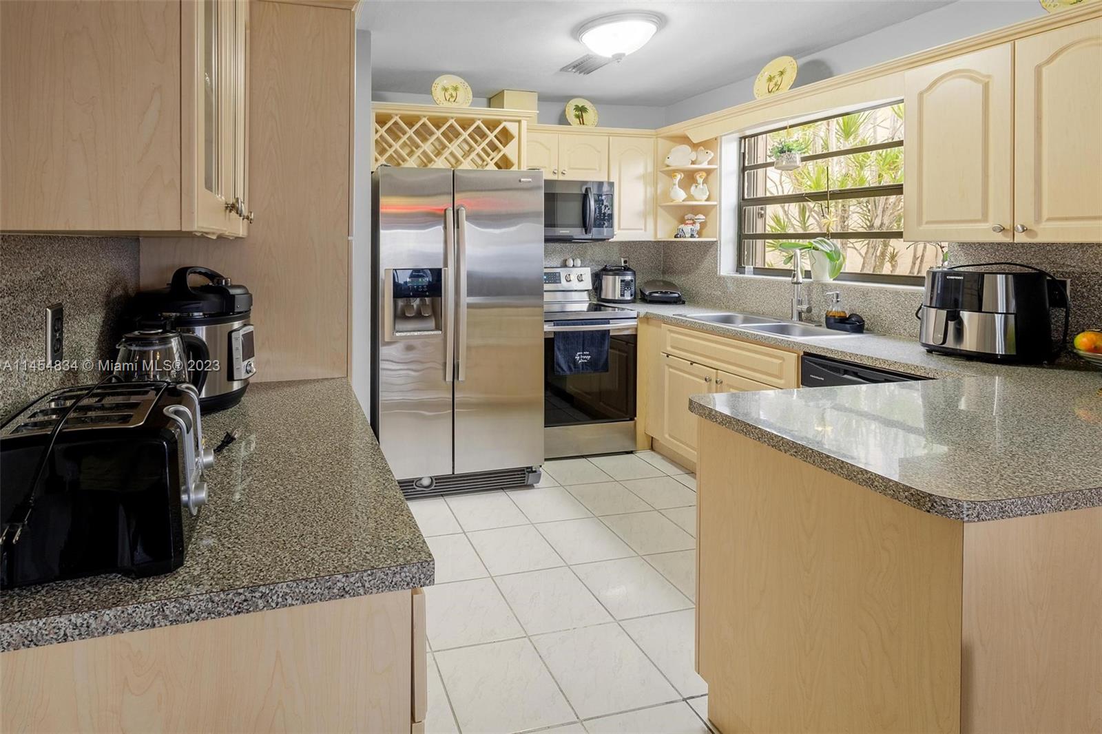 Tamiami Miami, FL 33182 - Photo 10 of 47 a kitchen with stainless steel appliances granite countertop a sink stove and refrigerator