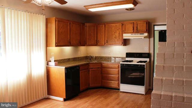 5221 Montgomery Street Springfield, VA 22151 - Photo 5 of 16 a kitchen with stainless steel appliances granite countertop a stove and a refrigerator