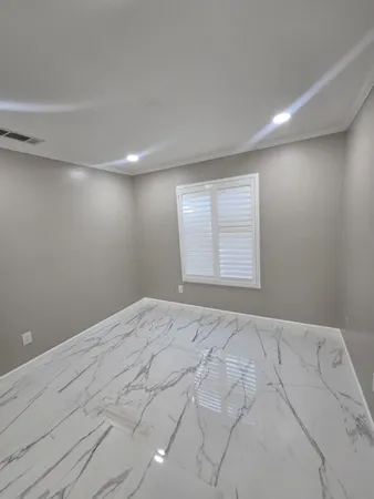 a view of an empty room and a window