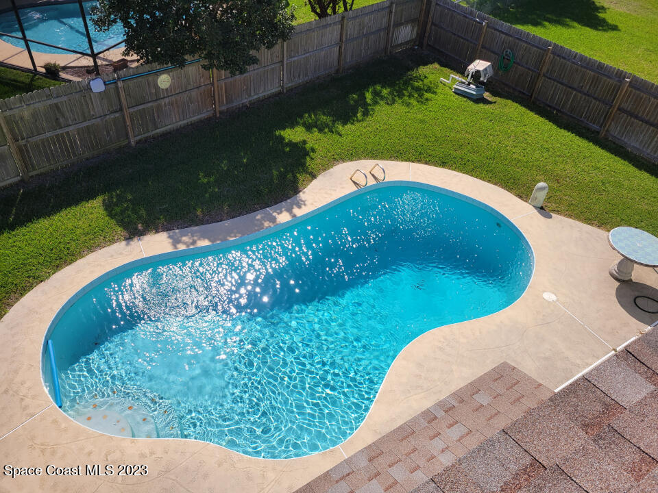 a view of a swimming pool with a yard