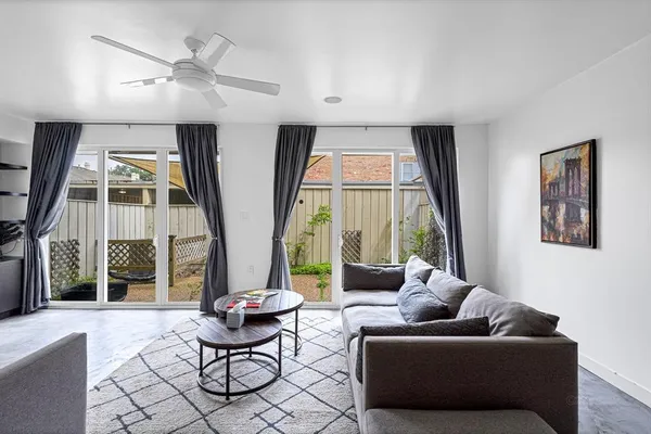 a living room with furniture and a large window