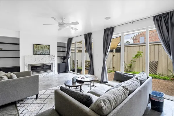 a living room with furniture fireplace and a large window