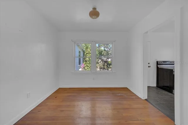 wooden floor in an empty room with a window