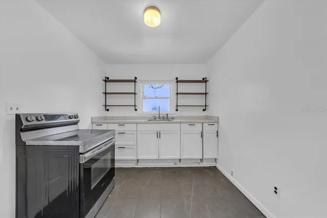 a kitchen with cabinets appliances and a sink