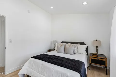 a bedroom with a bed and a desk