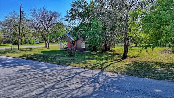 a view of a park with large trees