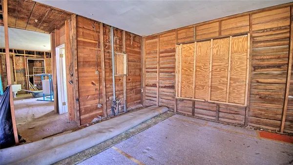 en empty room with sliding door and wooden floor