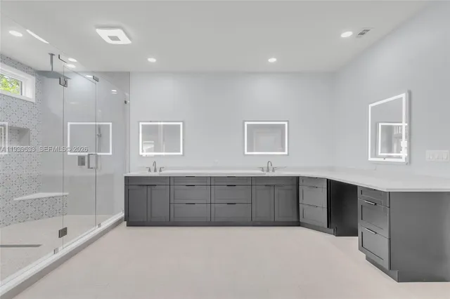 a spacious bathroom with double vanity sink and mirror